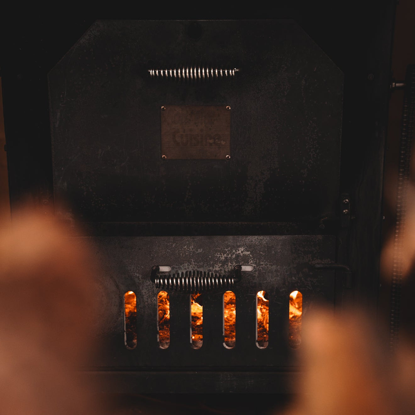 Black fireplace with flames visible through the glass