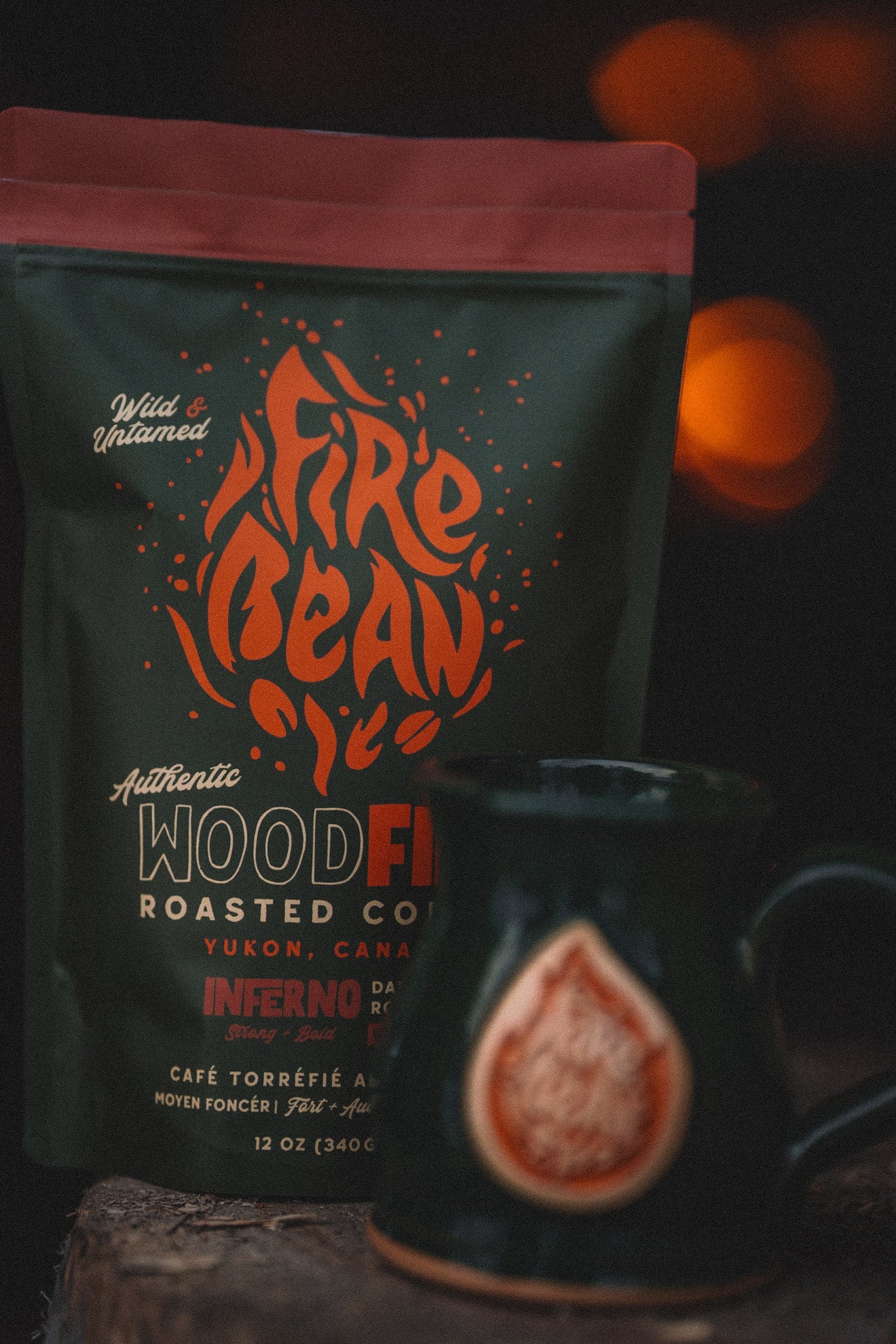 FireBean Coffee wood fire roasted coffee package with a black mug on a dark background