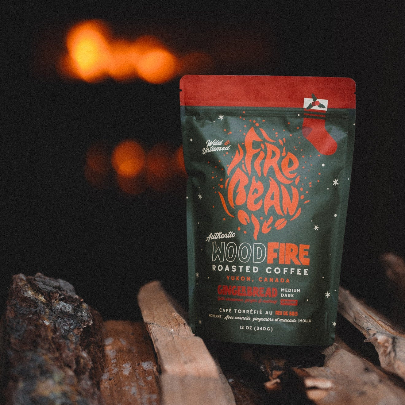 FireBean Wood Fire roasted coffee package on a log with a blurred fire in the background