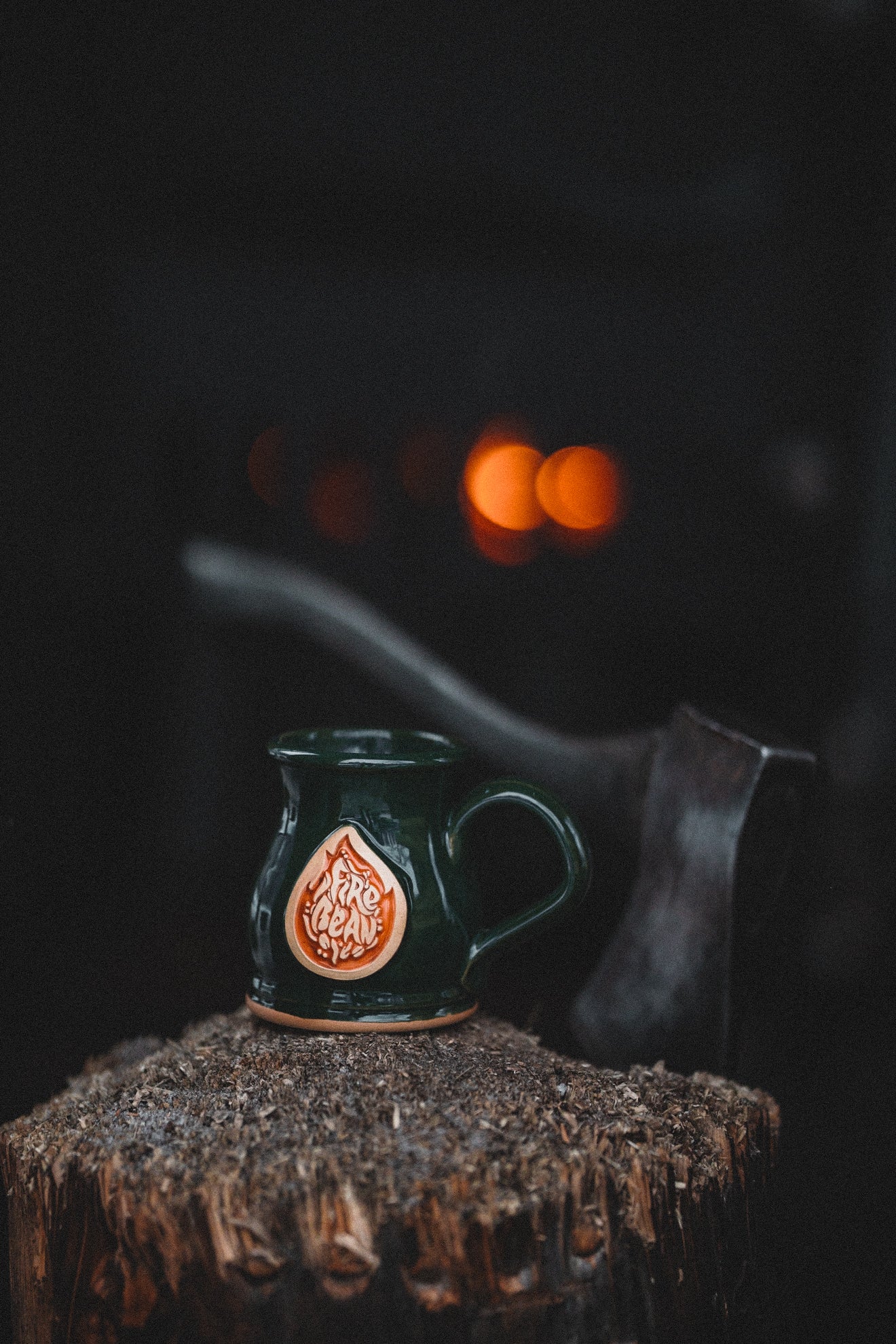 Green mug with a decorative emblem on a dark background