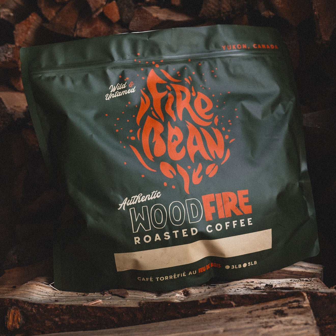 Fire Bean Woodfire Roasted Coffee package on a wooden background